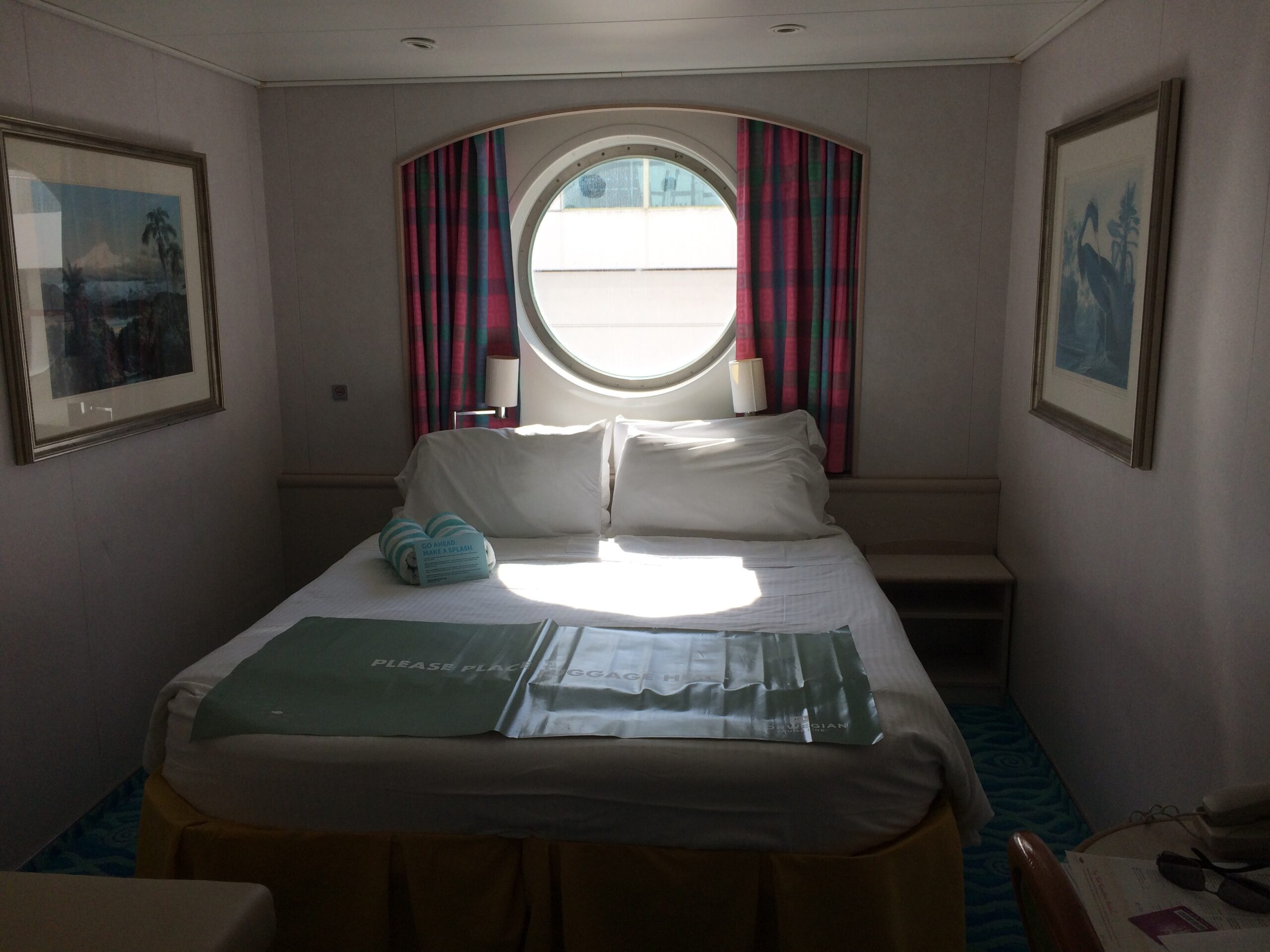 21 Things Nobody Tells You Before Your First Cruise (Learned the Hard Way) OX-category guaranteed oceanview stateroom on the NCL Sky, with round porthole window