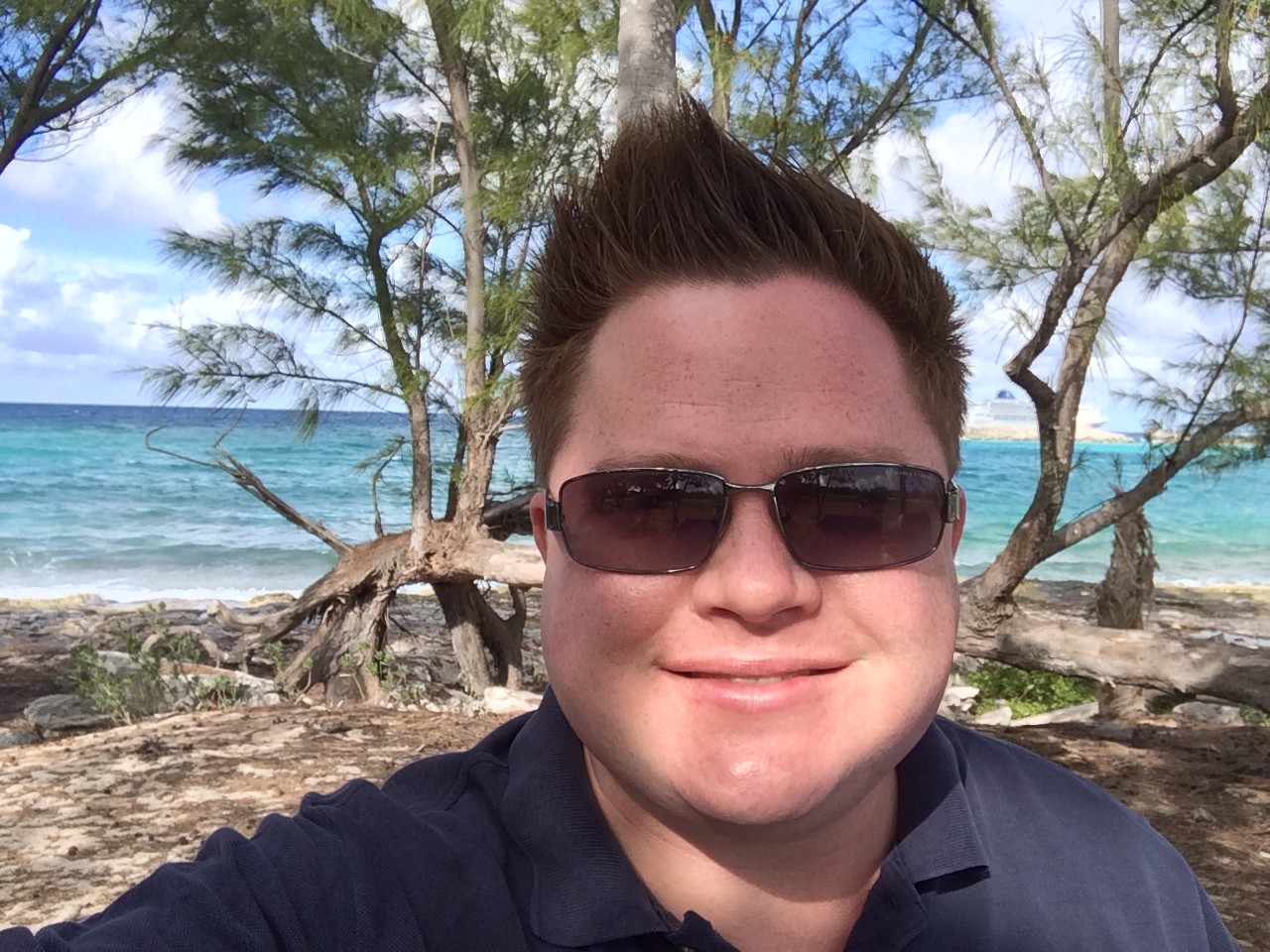 21 Things Nobody Tells You Before Your First Cruise (Learned the Hard Way) Selfie on the beach at Great Stirrup Cay with the ship visible offshore